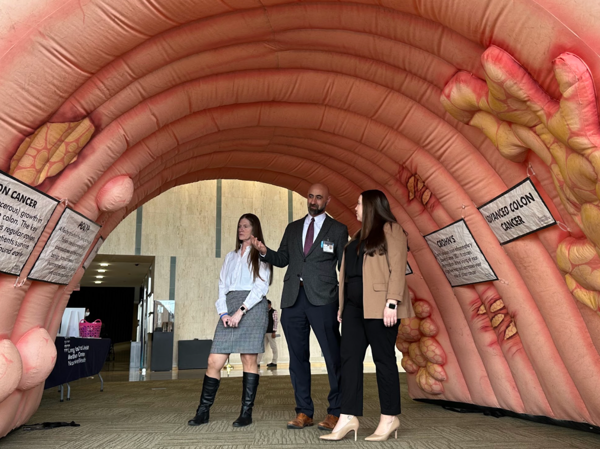 LIJ Medical center chief of colorectal surgery Dr. John Ricci (center) walks through the inflatable colon to raise awareness for colorectal cancers